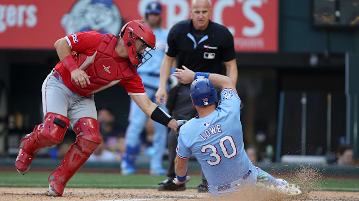 Sep 8, 2024; Arlington, Texas, USA; Los Angeles Angels catcher Matt Thaiss (21) tags out Texas Rangers first base Nathaniel Lowe (30) at home in the eighth inning at Globe Life Field. Mandatory Credit: Tim Heitman-Imagn Images