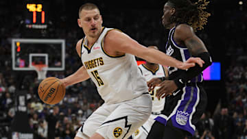 Apr 9, 2025; Sacramento, California, USA; Denver Nuggets center Nikola Jokic (15) controls the ball against Sacramento Kings guard Keon Ellis (23) during the second quarter at Golden 1 Center. Mandatory Credit: Ed Szczepanski-Imagn Images