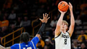 New Orleans Privateers guard Jamond Vincent (13) defends a shot attempt by Iowa Hawkeyes forward Cooper Koch (8) Sunday, Dec. 15, 2024 at Carver-Hawkeye Arena in Iowa City, Iowa.