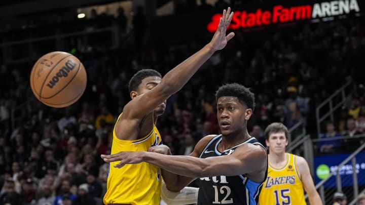 Jan 30, 2024; Atlanta, Georgia, USA; Atlanta Hawks forward De'Andre Hunter (12) passes the ball around Los Angeles Lakers forward Rui Hachimura (28) during the second half at State Farm Arena. Mandatory Credit: Dale Zanine-USA TODAY Sports