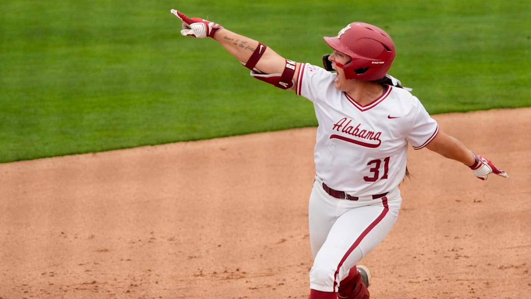 April 18, 2026; Tuscaloosa, AL, USA; Alabama batter Alexis Pupillo points to softball alumni in the left field stands as she celebrates her two-run homer in game 2 of the weekend series at Rhoads Stadium as the Crimson Tide hosted Kentucky.