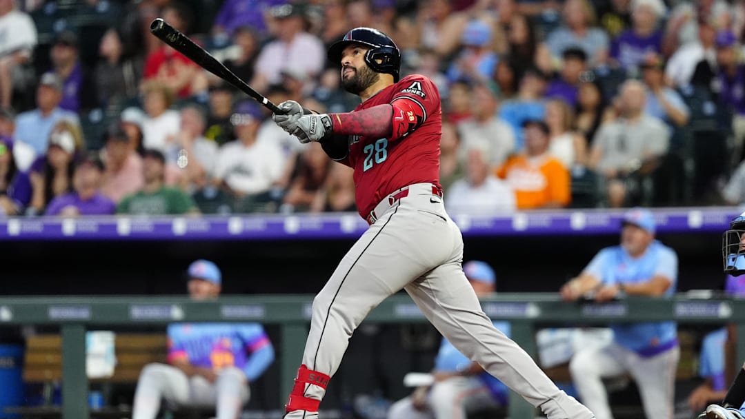 Jun 20, 2025; Denver, Colorado, USA; Arizona Diamondbacks third baseman Eugenio Suarez (28) hits a two run home run in the sixth inning against the Colorado Rockies at Coors Field. Mandatory Credit: Ron Chenoy-Imagn Images