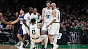 Apr 11, 2025; Boston, Massachusetts, USA; Boston Celtics guard Jrue Holiday (4) and center Luke Kornet (40) help forward Jayson Tatum (0) to his feet during the second half against the Charlotte Hornets at TD Garden. Mandatory Credit: Eric Canha-Imagn Images