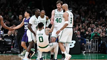 Apr 11, 2025; Boston, Massachusetts, USA; Boston Celtics guard Jrue Holiday (4) and .center Luke Kornet (40) help forward Jayson Tatum (0) to his feet during the second half against the Charlotte Hornets at TD Garden. Mandatory Credit: Eric Canha-Imagn Images