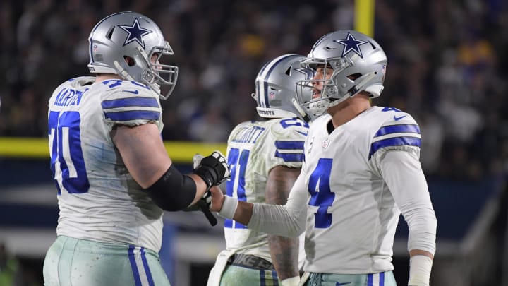 Dallas Cowboys quarterback Dak Prescott (4) and Dallas Cowboys offensive guard Zack Martin (70) react after a play in the second half against the Los Angeles Rams in a NFC Divisional playoff football game at Los Angeles Memorial Stadium. Mandatory Credit: Kirby Lee-USA TODAY Sports