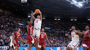 Mar 22, 2025; Providence, RI, USA; St. John's basketball guard RJ Luis Jr. (12) shoots against Arkansas Razorbacks guard Johnell Davis (1) during the first half of a second round men’s NCAA Tournament game at Amica Mutual Pavilion.