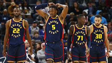 Dec 19, 2024; Memphis, Tennessee, USA; Golden State Warriors forward Andrew Wiggins (22), forward Kevon Looney (5), guard Dennis Schroder (71), and guard Stephen Curry (30) wait for play to resume during the third quarter against the Memphis Grizzlies at FedExForum. Mandatory Credit: Petre Thomas-Imagn Images