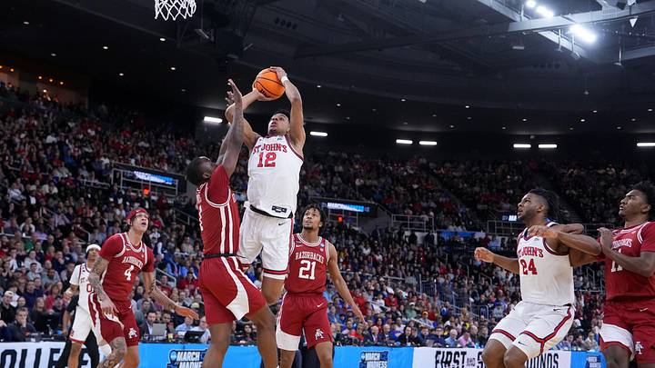 Mar 22, 2025; Providence, RI, USA; St. John's basketball guard RJ Luis Jr. (12) shoots against Arkansas Razorbacks guard Johnell Davis (1) during the first half of a second round men’s NCAA Tournament game at Amica Mutual Pavilion.
