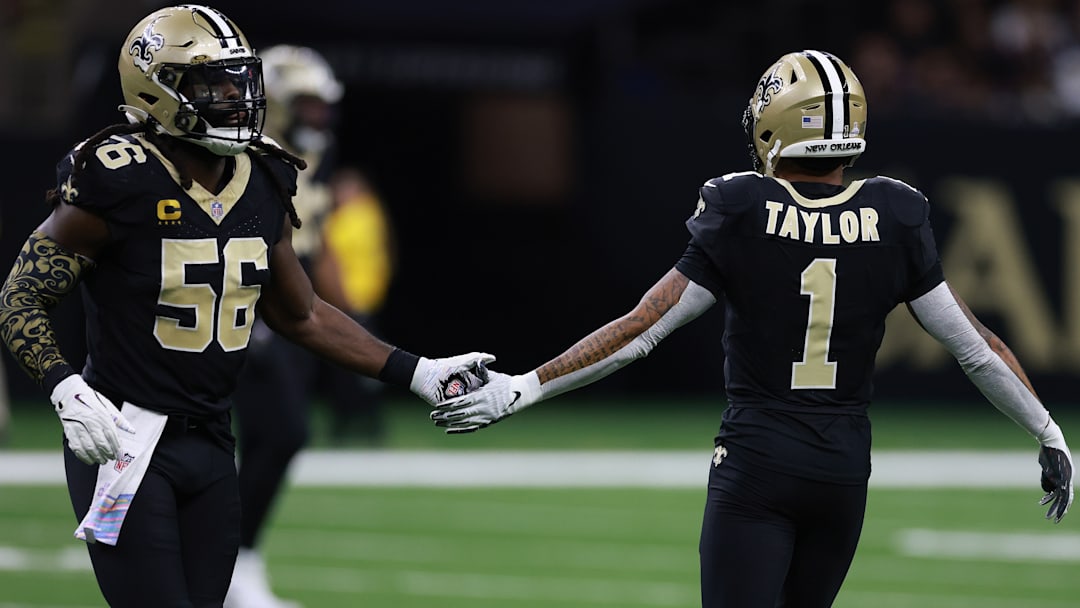 New Orleans Saints LB Demario Davis (56) and CB Alontae Taylor (1) after a stop against the New England Patriots on Oct. 12, 2025.
