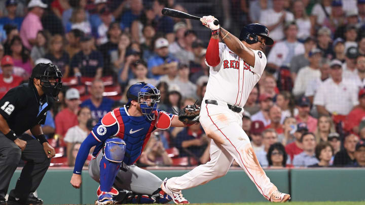 Aug 13, 2024; Boston, Massachusetts, USA; Boston Red Sox third baseman Rafael Devers (11) hits a single against the Texas Rangers during the fourth inning at Fenway Park. Mandatory Credit: Eric Canha-USA TODAY Sports