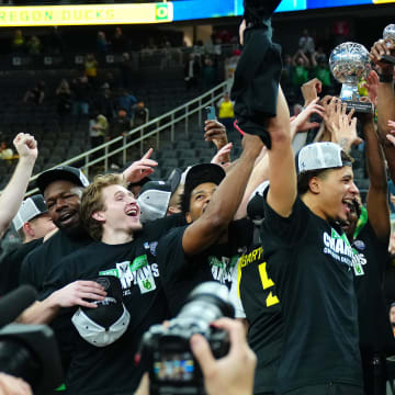 Mar 16, 2024; Las Vegas, NV, USA; Oregon Ducks players celebrate after defeating the Colorado Buffaloes 75-68 to win the Pac-12 Tournament championship at T-Mobile Arena.