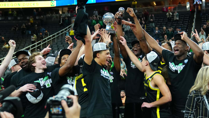 Mar 16, 2024; Las Vegas, NV, USA; Oregon Ducks players celebrate after defeating the Colorado Buffaloes 75-68 to win the Pac-12 Tournament championship at T-Mobile Arena.