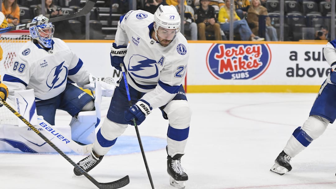Oct 28, 2025; Nashville, Tennessee, USA;  Tampa Bay Lightning defenseman Ryan McDonagh (27) clears the zone against the Nashville Predators during the third period at Bridgestone Arena. Mandatory Credit: Steve Roberts-Imagn Images
