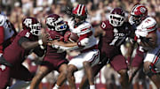 Nov 15, 2025; College Station, Texas, USA; Texas A&M Aggies linebacker Taurean York (21) tackles South Carolina Gamecocks running back Rahsul Faison (1) during the third quarter at Kyle Field. Mandatory Credit: Troy Taormina-Imagn Images