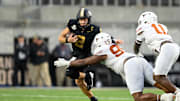 Oct 26, 2024; Nashville, Tennessee, USA;  Texas Longhorns defensive lineman Alfred Collins (95) tackles Vanderbilt Commodores quarterback Diego Pavia (2) for a loss during the second half at FirstBank Stadium. Mandatory Credit: Steve Roberts-Imagn Images