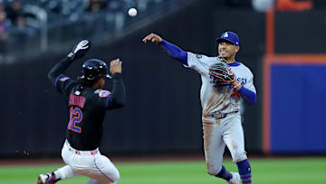 May 23, 2025; New York City, New York, USA; Los Angeles Dodgers shortstop Mookie Betts (50) forces out New York Mets shortstop Francisco Lindor (12) at second base then throws to first to complete a double play on a ball hit by Mets right fielder Juan Soto (not pictured) during the first inning at Citi Field. Mandatory Credit: Brad Penner-Imagn Images