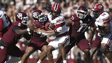 Nov 15, 2025; College Station, Texas, USA; Texas A&M Aggies linebacker Taurean York (21) tackles South Carolina Gamecocks running back Rahsul Faison (1) during the third quarter at Kyle Field. Mandatory Credit: Troy Taormina-Imagn Images
