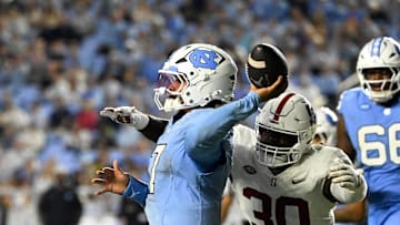 Nov 8, 2025; Chapel Hill, North Carolina, USA; North Carolina Tar Heels quarterback Gio Lopez (7) passes the ball as Stanford Cardinal linebacker Ese Dubre (30) pressures in the third quarter at Kenan Stadium. 