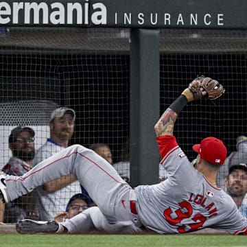 Sep 5, 2024; Arlington, Texas, USA; Los Angeles Angels third baseman Charles Leblanc (33) makes a sliding catch of foul ball hit by Texas Rangers third baseman Josh Jung (6) during the game at Globe Life Field. Mandatory Credit: Jerome Miron-Imagn Images