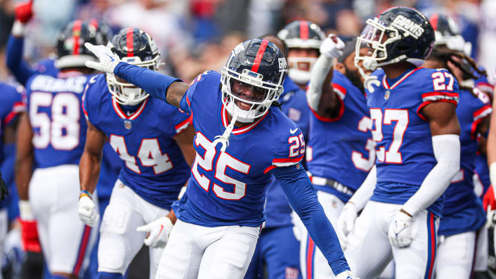 Oct 22, 2023; East Rutherford, New Jersey, USA; New York Giants cornerback Deonte Banks (25) celebrates after an interception against the Washington Commanders during the first half at MetLife Stadium.  