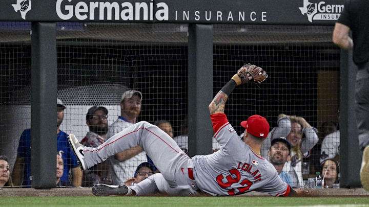 Sep 5, 2024; Arlington, Texas, USA; Los Angeles Angels third baseman Charles Leblanc (33) makes a sliding catch of foul ball hit by Texas Rangers third baseman Josh Jung (6) during the game at Globe Life Field. Mandatory Credit: Jerome Miron-Imagn Images