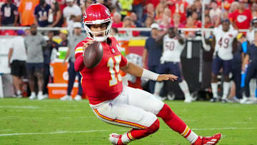 Aug 22, 2025; Kansas City, Missouri, USA; Kansas City Chiefs quarterback Patrick Mahomes (15) runs for a first down against the Chicago Bears during the game at GEHA Field at Arrowhead Stadium. Mandatory Credit: Denny Medley-Imagn Images