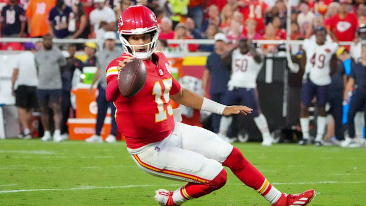 Aug 22, 2025; Kansas City, Missouri, USA; Kansas City Chiefs quarterback Patrick Mahomes (15) runs for a first down against the Chicago Bears during the game at GEHA Field at Arrowhead Stadium. Mandatory Credit: Denny Medley-Imagn Images