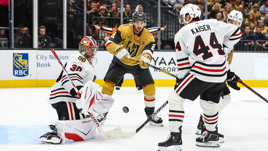 Sep 29, 2026; Las Vegas, Nevada, USA;  Vegas Golden Knights center Brett Howden (21) looks to redirect the puck towards the goal being defended by Chicago Blackhawks goaltender Spencer Knight (30) during the third period at T-Mobile Arena.  Mandatory Credit: Christopher Trim-Imagn Images