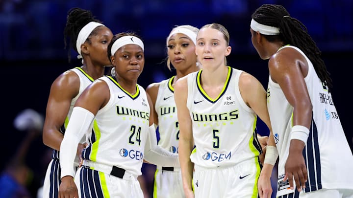 Jun 17, 2025; Arlington, Texas, USA;  Dallas Wings guard Paige Bueckers (5) and Dallas Wings guard Arike Ogunbowale (24) celebrates with teammates during the second half against the Golden State Valkyries at College Park Center. Mandatory Credit: Kevin Jairaj-Imagn Images