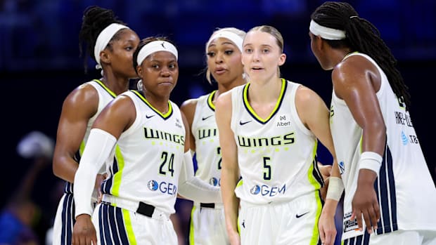 Wings guard Paige Bueckers (5) and Wings guard Arike Ogunbowale (24) celebrates with teammates vs. the Valkyries.