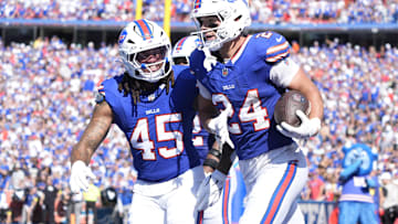 Buffalo Bills safety Cole Bishop and outside linebacker Shaq Thompson celebrate after an interception.