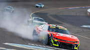Nov 2, 2025; Avondale, Arizona, USA; Smoke comes from the car of NASCAR Cup Series driver William Byron (24) after hitting the wall with a tire failure in the closing laps of the NASCAR Championship race at Phoenix Raceway.