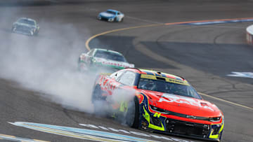Nov 2, 2025; Avondale, Arizona, USA; Smoke comes from the car of NASCAR Cup Series driver William Byron (24) after hitting the wall with a tire failure in the closing laps of the NASCAR Championship race at Phoenix Raceway.