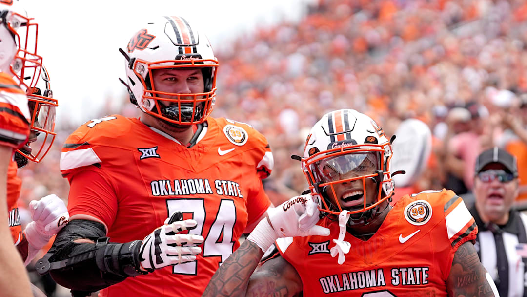 Oklahoma State's Ollie Gordon II (0) celebrates his touchdown with Preston Wilson (74) in the first half of the college football game between the Oklahoma State Cowboys and South Dakota State Jackrabbits at Boone Pickens Stadium in Stillwater, Okla., Saturday, Aug., 31, 2024.