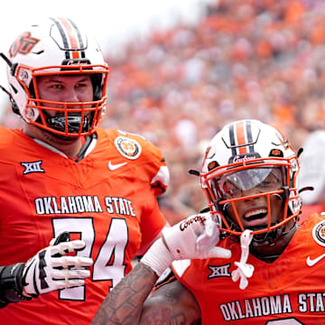 Oklahoma State's Ollie Gordon II (0) celebrates his touchdown with Preston Wilson (74) in the first half of the college football game between the Oklahoma State Cowboys and South Dakota State Jackrabbits at Boone Pickens Stadium in Stillwater, Okla., Saturday, Aug., 31, 2024.