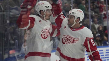 Nov 8, 2024; Toronto, Ontario, CAN; Detroit Red Wings forward Alex DeBrincat (93) congratulates forward Dylan Larkin (71) on his goal against the Toronto Maple Leafs during the second period at Scotiabank Arena. Mandatory Credit: John E. Sokolowski-Imagn Images