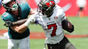 Sep 28, 2025; Tampa, Florida, USA; Tampa Bay Buccaneers running back Bucky Irving (7) attempts to stiff arm Philadelphia Eagles cornerback Cooper Dejean (33) during the first quarter at Raymond James Stadium. Mandatory Credit: Nathan Ray Seebeck-Imagn Images
