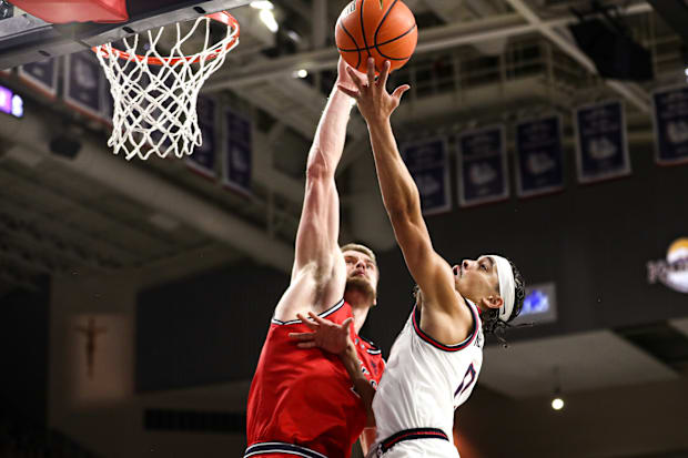 Saint Mary's center Mitchell Saxen and Gonzaga guard Ryan Nembhard.