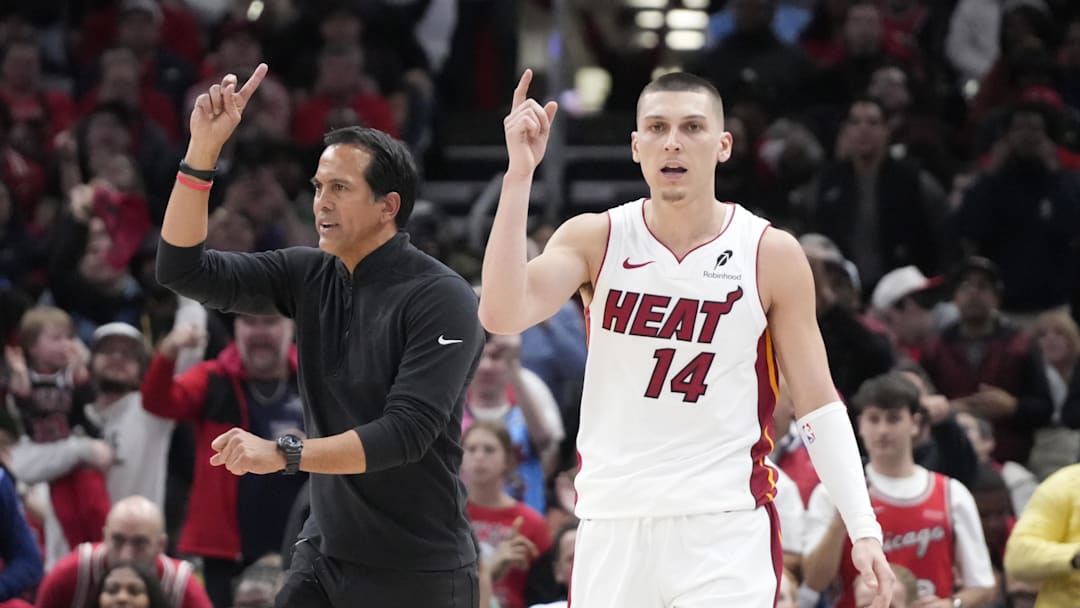 Apr 16, 2025; Chicago, Illinois, USA; Miami Heat guard Tyler Herro (14) and head coach Erik Spoelstra ask for a replay against the Chicago Bulls during the second half at United Center. Mandatory Credit: David Banks-Imagn Images