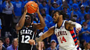 Feb 15, 2025; Oxford, Mississippi, USA; Mississippi State Bulldogs guard Josh Hubbard (12) drives to the basket as Mississippi Rebels guard Dre Davis (14) defends during the first half at The Sandy and John Black Pavilion at Ole Miss. Mandatory Credit: Petre Thomas-Imagn Images