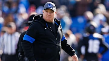 Nov 30, 2024; Lexington, Kentucky, USA; Kentucky Wildcats head coach Mark Stoops walks onto the field before the game against the Louisville Cardinals at Kroger Field. Mandatory Credit: Jordan Prather-Imagn Images