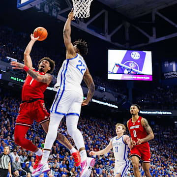 Dec 14, 2024; Lexington, Kentucky, USA; Louisville Cardinals guard J'Vonne Hadley (1) goes to the basket against Kentucky Wildcats center Amari Williams (22) during the first half at Rupp Arena at Central Bank Center. Mandatory Credit: Jordan Prather-Imagn Images