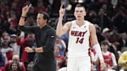 Apr 16, 2025; Chicago, Illinois, USA; Miami Heat guard Tyler Herro (14) and head coach Erik Spoelstra ask for a replay against the Chicago Bulls during the second half at United Center. Mandatory Credit: David Banks-Imagn Images
