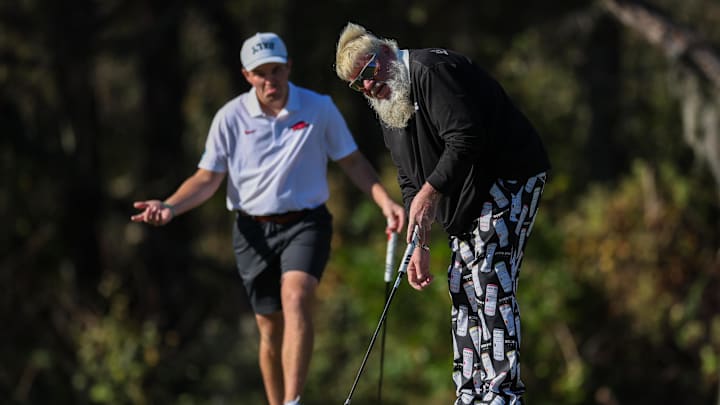 Dec 22, 2024; Orlando, Florida, [USA]; John Daly sinks a putt on the first green during the PNC Championship at The Ritz-Carlton Golf Club. Mandatory Credit: Nathan Ray Seebeck-Imagn Images