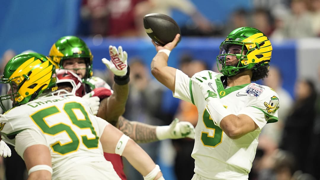 Jan 9, 2026; Atlanta, GA, USA; Oregon Ducks quarterback Dante Moore (5) passes against the Indiana Hoosiers during the third quarter of the 2025 Peach Bowl and semifinal game of the College Football Playoff at Mercedes-Benz Stadium. Mandatory Credit: Dale Zanine-Imagn Images
