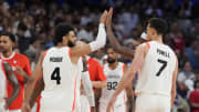 Jul 30, 2024; Villeneuve-d'Ascq, France; Canada players celebrate after defeating Australia in a men's group stage basketball match during the Paris 2024 Olympic Summer Games at Stade Pierre-Mauroy. Mandatory Credit: John David Mercer-USA TODAY Sports
