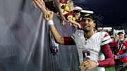 Sep 23, 2024; Cincinnati, Ohio, USA; Washington Commanders quarterback Jayden Daniels (5) celebrates with fans following the win against the Cincinnati Bengals at Paycor Stadium. Mandatory Credit: Joseph Maiorana-Imagn Images