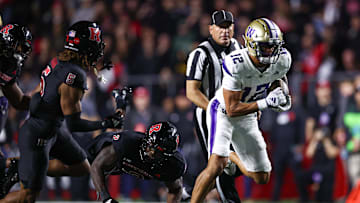 Sep 27, 2024; Piscataway, New Jersey, USA; Washington Huskies wide receiver Denzel Boston (12) breaks a tackle by Rutgers Scarlet Knights linebacker Moses Walker (2) for a touchdown during the second half at SHI Stadium. Mandatory Credit: Vincent Carchietta-Imagn Images