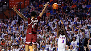 Feb 15, 2025; Gainesville, Florida, USA; Florida Gators guard Denzel Aberdeen (11) makes a three-point basket over South Carolina Gamecocks guard Arden Conyers (21) during the second half at Exactech Arena at the Stephen C. O'Connell Center. Mandatory Credit: Matt Pendleton-Imagn Images