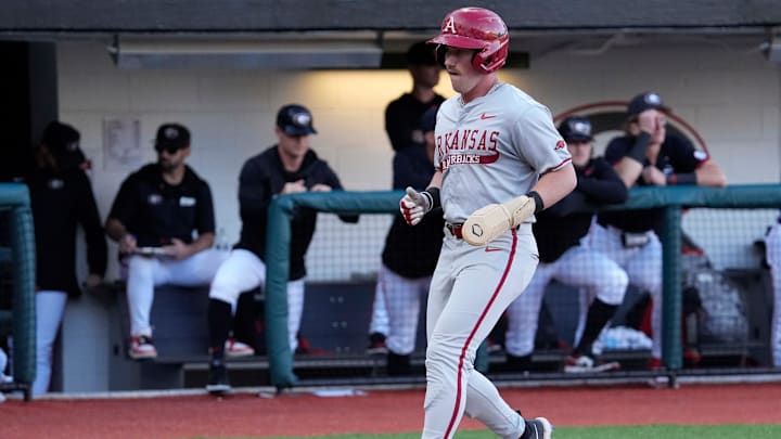 Arkansas outfielder Logan Maxwell (22) scores a run during a NCAA baseball game against Georgia in Athens, Ga., on Friday, April 11, 2025.